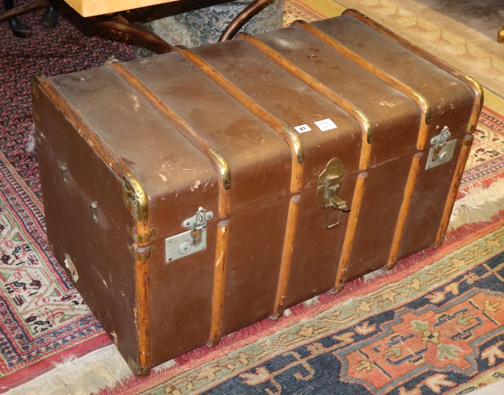 An early 20th century travelling trunk containing a large quantity of assorted linen and mixed textiles, trunk W.90cm